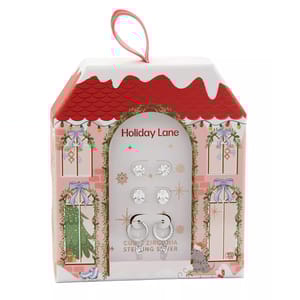 Set of cubic zirconia sterling silver earrings in a holiday-themed box with a red roof and festive decorations.
