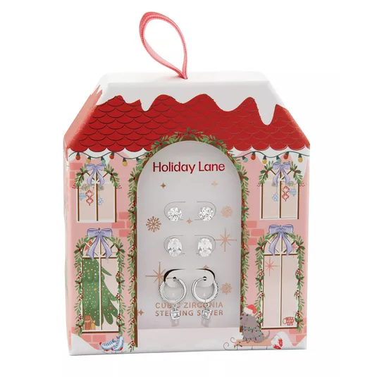 Set of cubic zirconia sterling silver earrings in a holiday-themed box with a red roof and festive decorations.