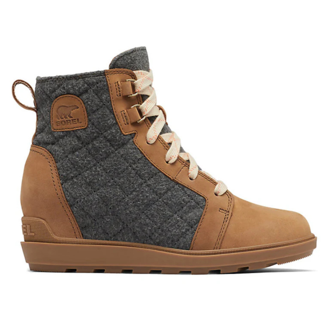 A Sorel ankle boot featuring a tan leather toe, heel, and details with a quilted gray fabric upper, and light colored laces.