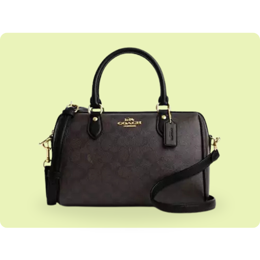 A Coach handbag featuring a dark brown leather body with a subtle logo pattern, gold-tone hardware, dual handles, and an adjustable shoulder strap.
