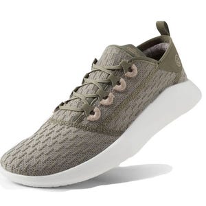 Allbirds Super Light Trainers are lightweight sneakers featuring a breathable knit upper in olive green, with subtle white soles and unique lace loops for easy adjustability.