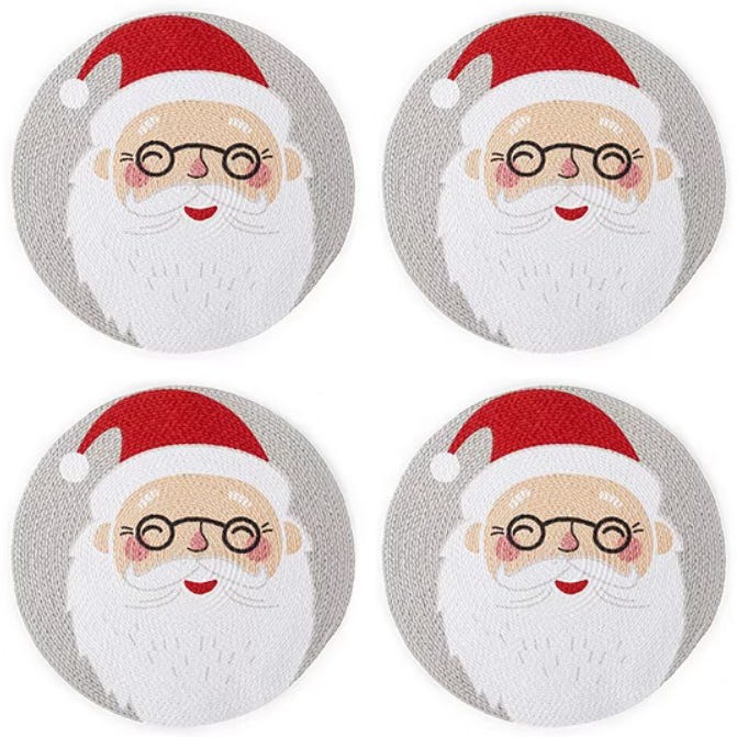 Four circular coasters feature a cute Santa Claus design with a red hat, glasses, and a white beard, set against a gray background.