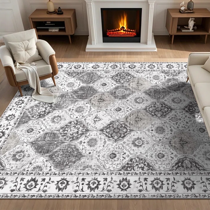 A living room features a patterned area rug with a floral and geometric design, placed between two armchairs and a sofa, in front of a lit fireplace.
