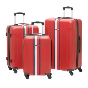 Three red hard-shell Tommy Hilfiger suitcases with a horizontal blue and white stripe design, featuring telescoping handles and spinner wheels.