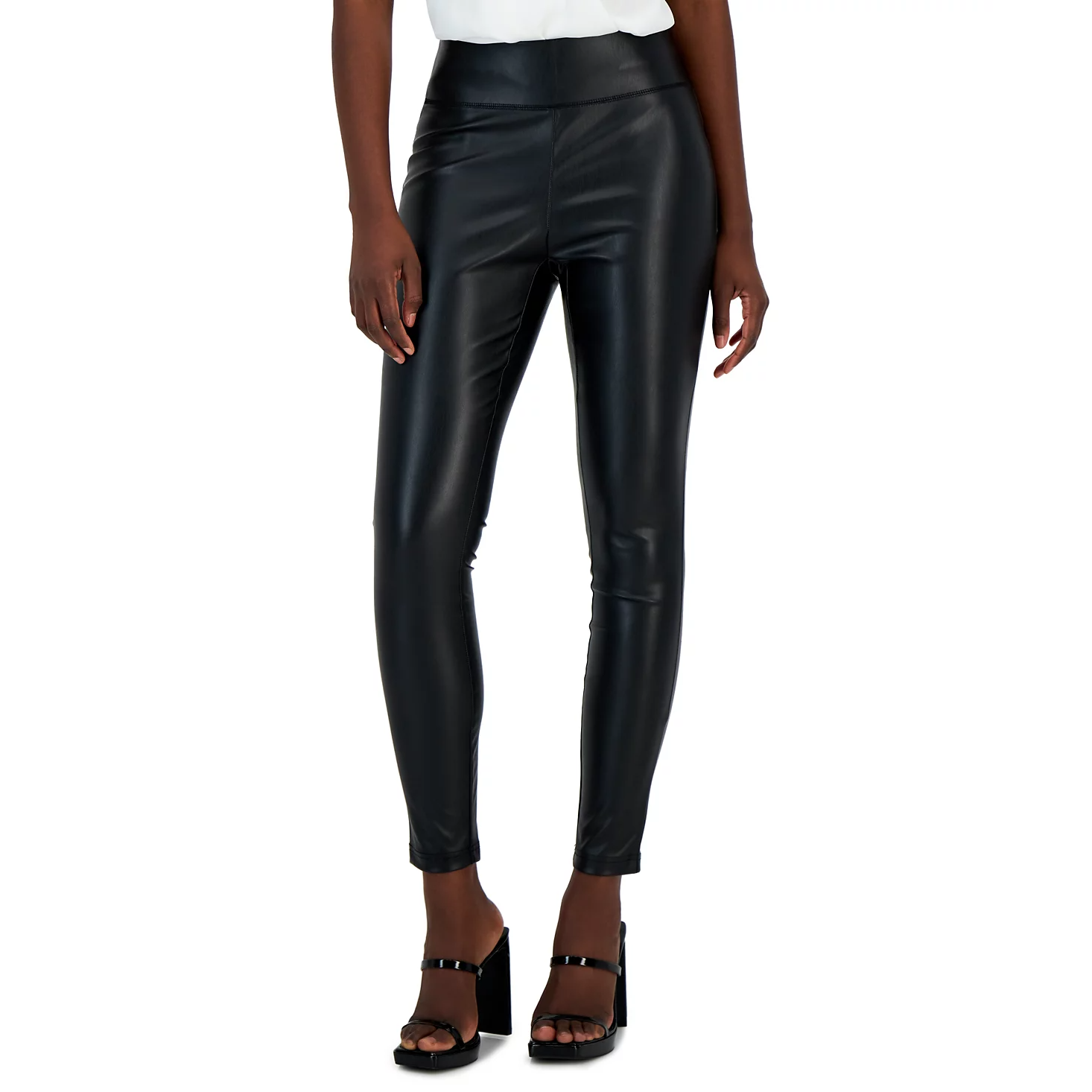 Black faux leather leggings paired with black high-heeled sandals.