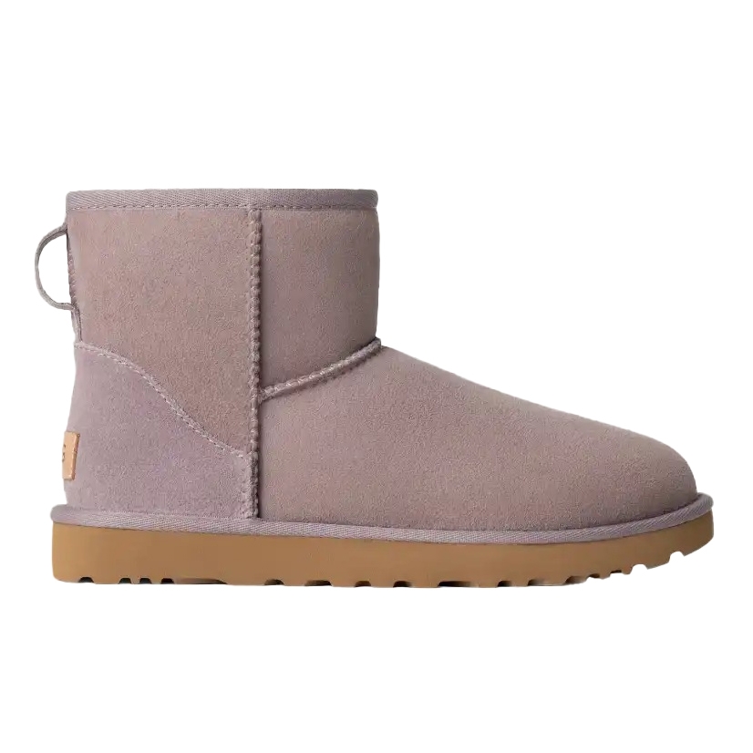 A short tan suede ankle boot with a pull tab at the back and a rubber sole.