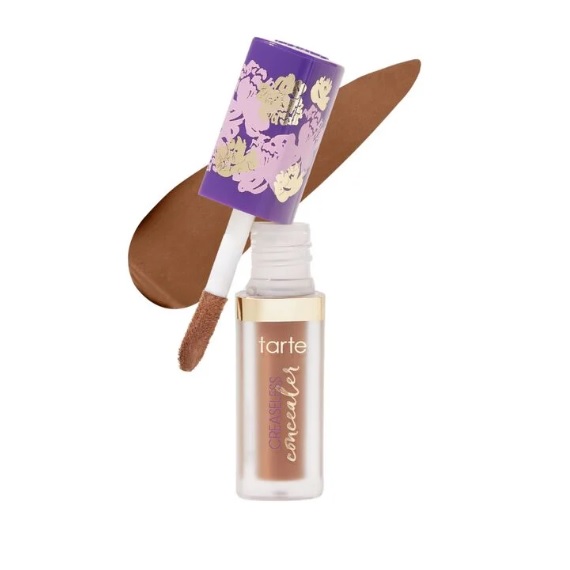 Tarte Creaseless Concealer, featuring a floral-patterned purple cap with an applicator. The concealer is a medium-dark shade.