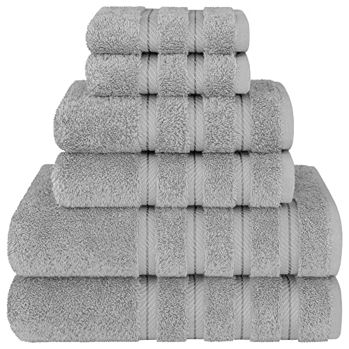 A set of grey Turkish cotton towels, including two bath towels, two hand towels, and two washcloths, stacked neatly.