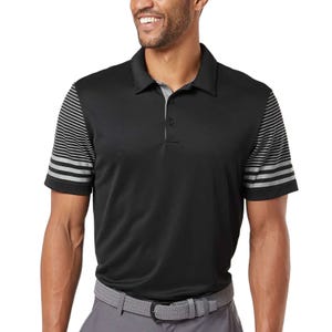 A man is wearing a black polo shirt with striped sleeves and a collar, paired with gray pants and a braided belt.