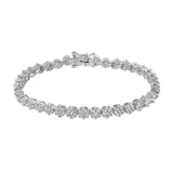 A white gold tennis bracelet featuring a continuous line of round-cut diamonds, secured with a clasp.