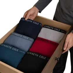 A drawer holds neatly organized men's underwear with \“Kenneth Cole\“ branding, featuring various colors including navy, light blue, black, grey, and red.
