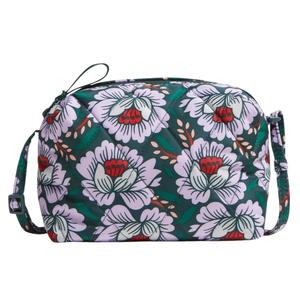 A quilted floral patterned bag with a light purple flower design, adjustable strap, and a zipper closure.