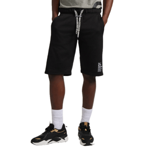 Black fleece shorts with a drawstring waistband featuring white text. The shorts have a small logo patch on the left leg and are paired with white socks and black sneakers with gold accents.
