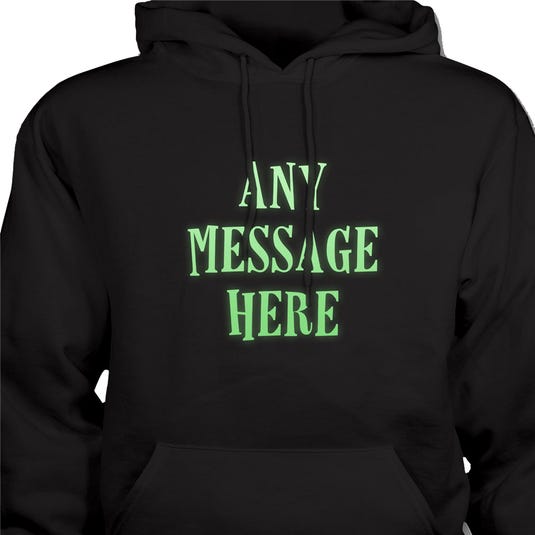 A black hoodie featuring the text \“ANY MESSAGE HERE\“ in large, glowing green letters on the front.