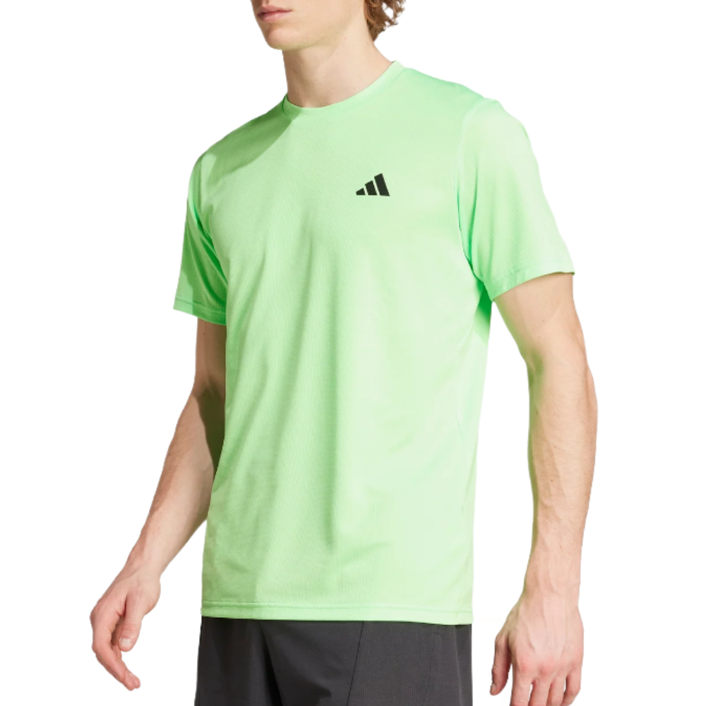 A light green athletic t-shirt with a black logo on the chest, paired with dark shorts.