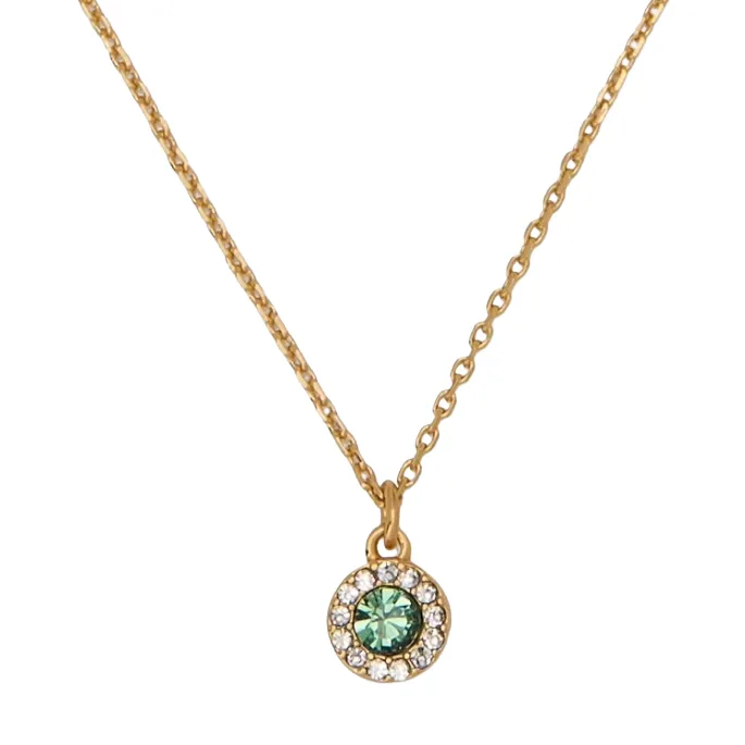A gold necklace with a circular pendant featuring a central green gemstone surrounded by small clear stones.