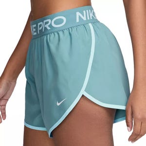 Light blue Nike Pro athletic shorts featuring an elastic waistband with the Nike logo and a small Nike swoosh near the hem.