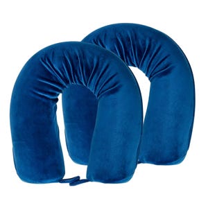 Two blue U-shaped travel pillows with a soft, plush fabric and gathered detailing on the inner curve for added comfort.