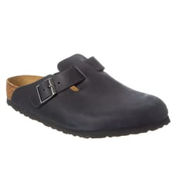 A dark-colored slip-on shoe with a cork footbed and an adjustable buckle strap across the top.