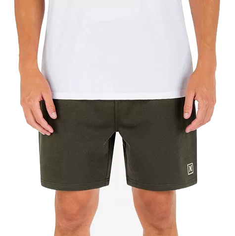 Dark green Hurley sweat shorts with a white logo near the hem, featuring a simple and comfortable design, paired with a white shirt.