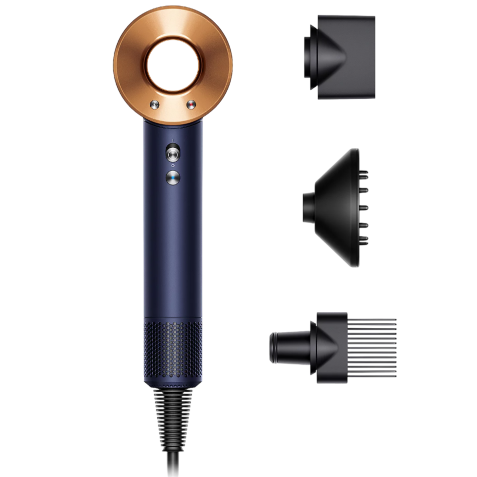 A hair dryer with a circular copper ring design and navy blue handle, accompanied by three attachments: a smoothing nozzle, diffuser, and comb attachment.