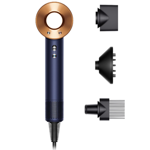 A hair dryer with a circular copper ring design and navy blue handle, accompanied by three attachments: a smoothing nozzle, diffuser, and comb attachment.