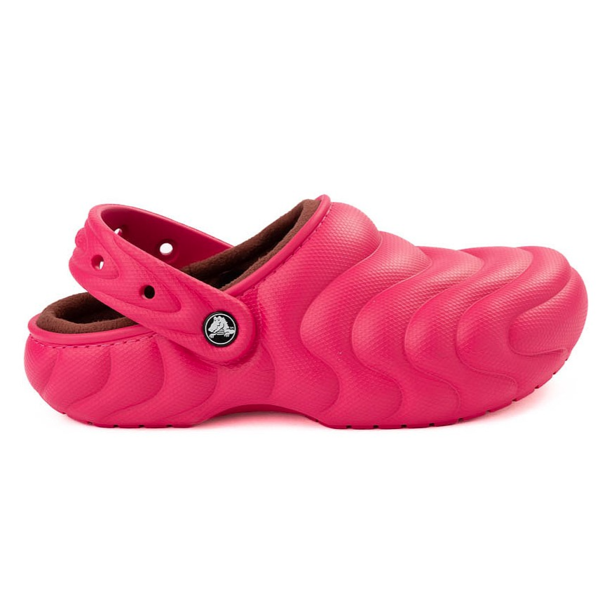 Bright pink textured clog with a strap, featuring a wave pattern and a lined interior for added comfort.