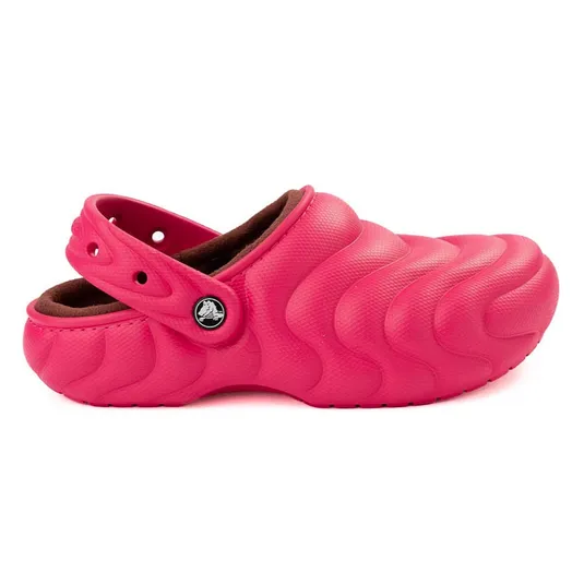 Bright pink textured clog with a strap, featuring a wave pattern and a lined interior for added comfort.