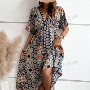 A woman is wearing a V-neck, short-sleeve maxi dress with a high slit and a bohemian-style print.