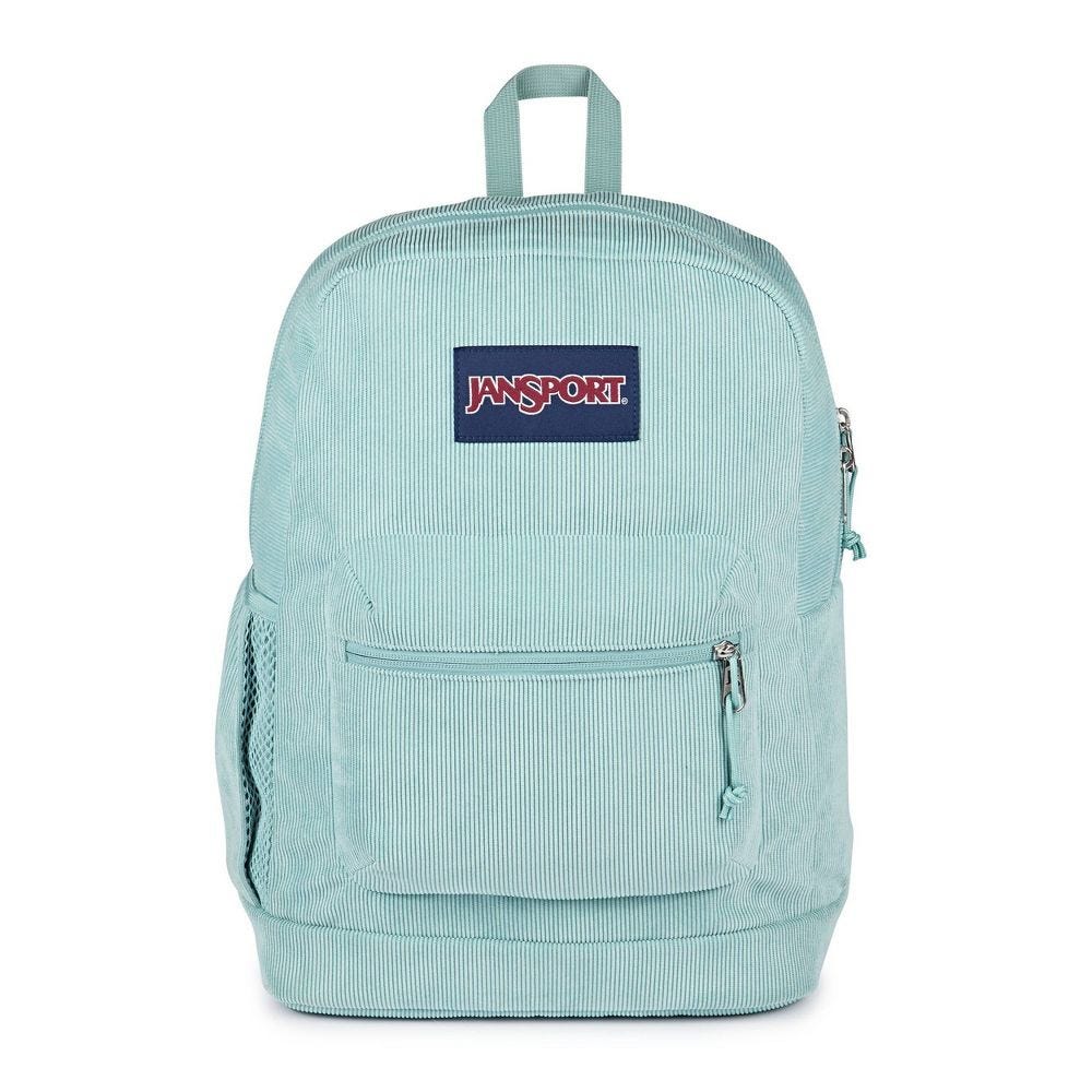 Light blue JanSport backpack featuring a front zip pocket, side mesh pocket, and top handle. Made from corduroy material with the JanSport logo on the front.