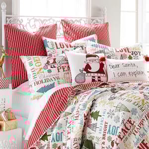 Levtex Santa Claus Lane Quilt Set features a festive design with Santa illustrations, holiday phrases, and bright colors like red, green, and white. It includes a quilt and matching pillow shams, creating a cheerful Christmas-themed bedding ensemble.