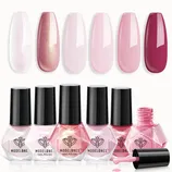 A collection of Modelones nail polishes includes six shades ranging from pearlescent white to deep pink. The bottles have a geometric shape with a black cap.