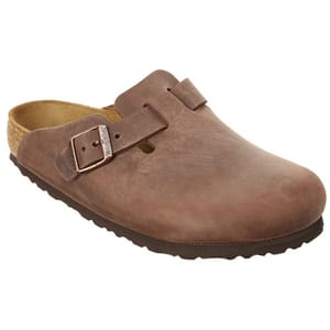 A brown leather clog with a buckle strap and cork footbed, featuring a textured rubber sole.