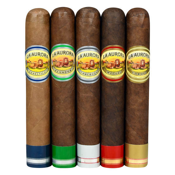 Five cigars from La Aurora with bands labeled Connecticut, Ecuador, Cameroon, Maduro, and Corojo, each featuring distinct colored foot bands: blue, green, white, red, and gold, respectively.