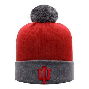 A red and gray beanie with a pom-pom on top, featuring the Indiana University logo on the folded cuff.