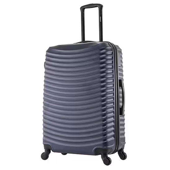 Dark-colored hard-shell suitcase with a wavy surface texture, extendable handle, and four wheels for easy maneuverability.
