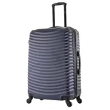 Dark-colored hard-shell suitcase with a wavy surface texture, extendable handle, and four wheels for easy maneuverability.
