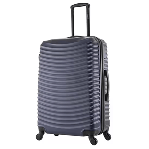 Dark-colored hard-shell suitcase with a wavy surface texture, extendable handle, and four wheels for easy maneuverability.
