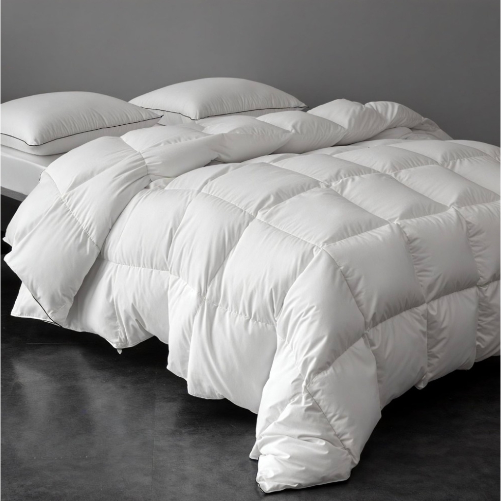 Queen Downfort Comforter: A plush, white, quilted comforter with a grid pattern featuring a thick, fluffy appearance.