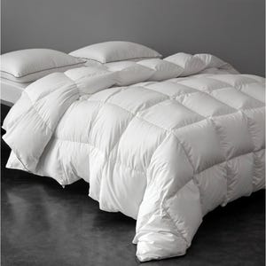 Queen Downfort Comforter: A plush, white, quilted comforter with a grid pattern featuring a thick, fluffy appearance.