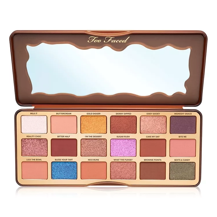 Too Faced eye shadow palette featuring 18 shades with names labeled, ranging from matte neutrals to pops of color, in a chocolate-bar-themed case.