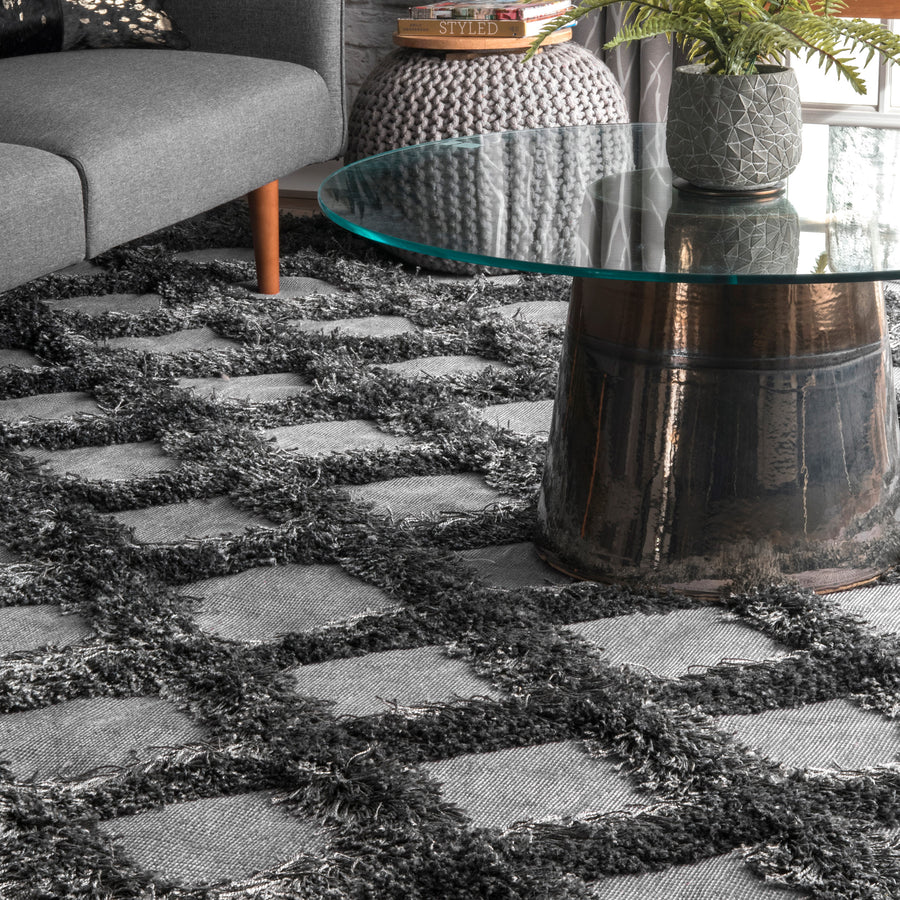 A gray shaggy area rug with a textured diamond trellis pattern, featuring thick, plush elements and a soft appearance.
