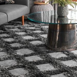 A gray shaggy area rug with a textured diamond trellis pattern, featuring thick, plush elements and a soft appearance.