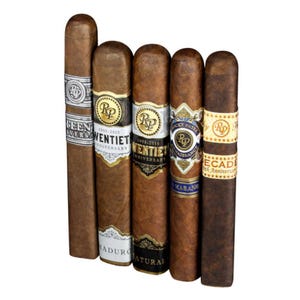 5pk of Rocky Patel Cigars includes varieties like the Fifteenth Anniversary, Twentieth Anniversary (Maduro and Natural), Renaissance Habano, and Decade 10th Anniversary. Each cigar features detailed band designs and varied wrapper shades.