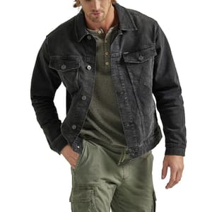 A man wearing a black denim jacket over a green henley shirt with olive cargo pants.