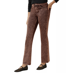 Brown denim jeans with a vintage wash and flared cut, paired with black flat shoes featuring a mesh design and buckle detail.
