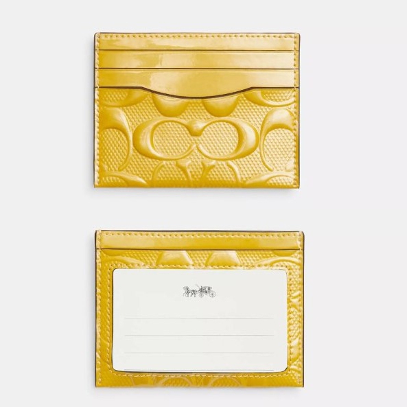 A yellow embossed cardholder with multiple slots on the front and a label slot on the back.