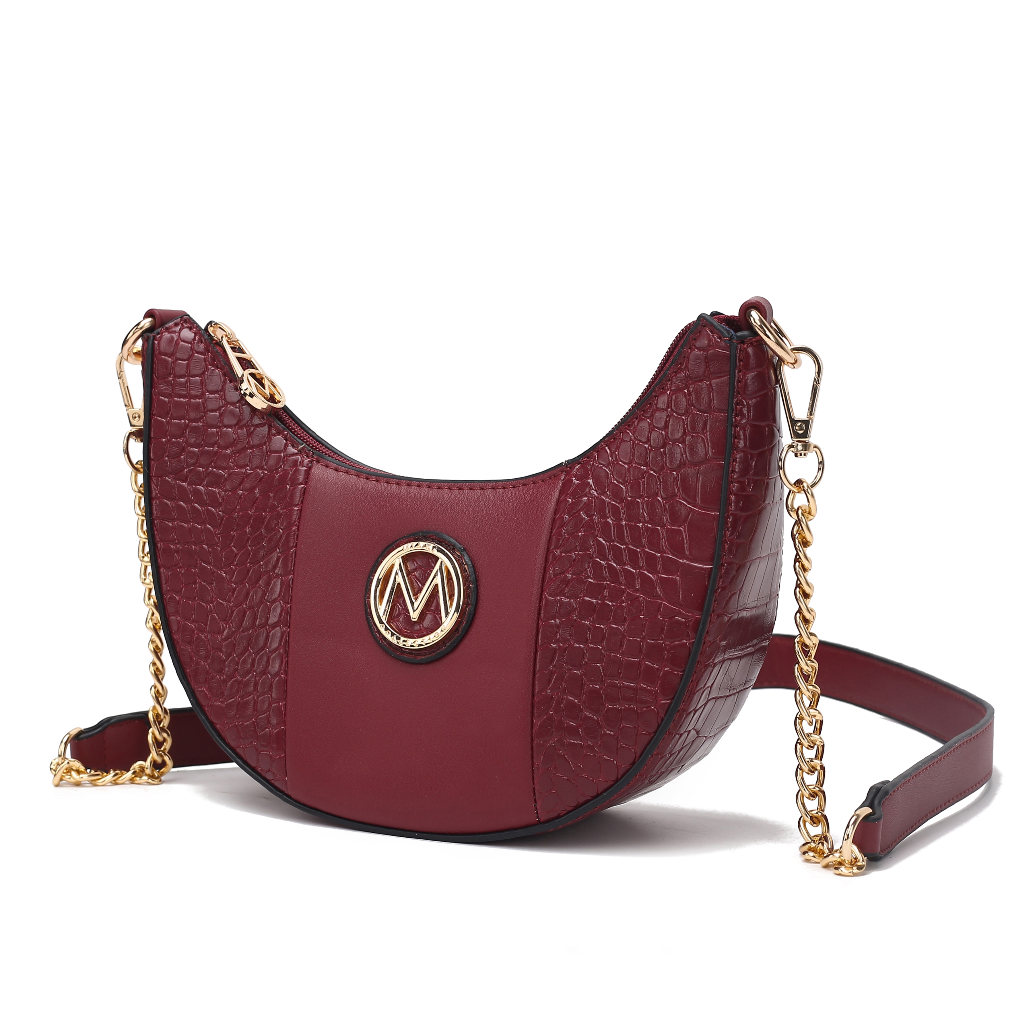 A stylish burgundy crossbody bag with a gold chain strap and crocodile texture detailing, featuring a circular logo with an \“M.\“