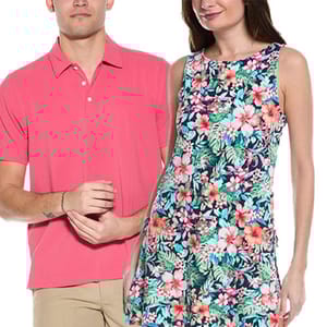 A man wears a short-sleeve, collared pink shirt with beige pants, and a woman in a sleeveless dress features a colorful, floral pattern.