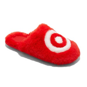Red fuzzy slippers with a white bullseye design on top, resembling a fluffy slide-on style.